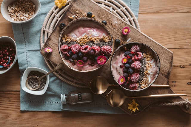 A smoothie bowl with berries and nuts for toppings.
