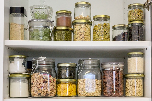 A stocked pantry with assorted glass containers filled with a variety of grains and spices