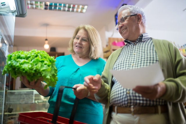 Senior couple buying vegetables