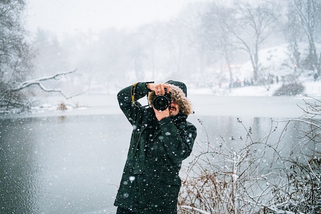 Photographer taking pictures in the snow