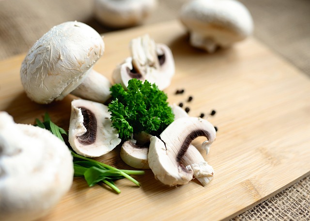Mushrooms with herbs and spices on a wooden chopping board