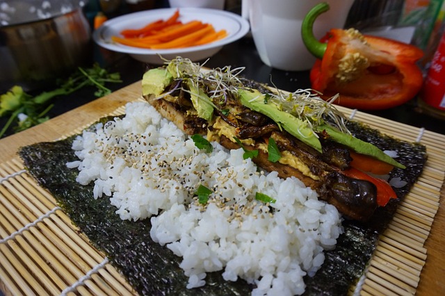 Sushi made of rice avocado, grilled eggplants and sprouts