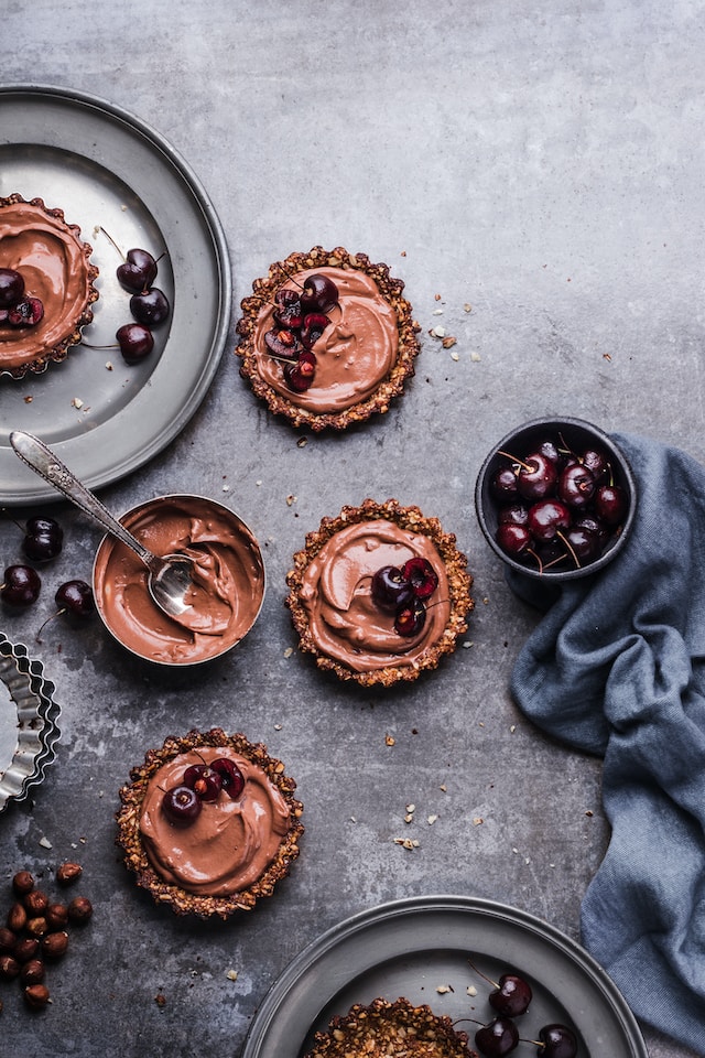 Mini chocolate tarts with cherries for toppings