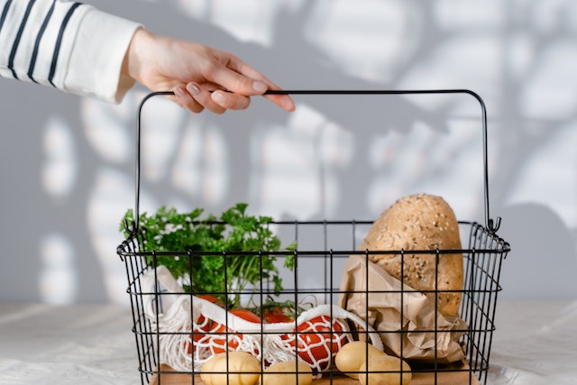 Person holding a grocery basket